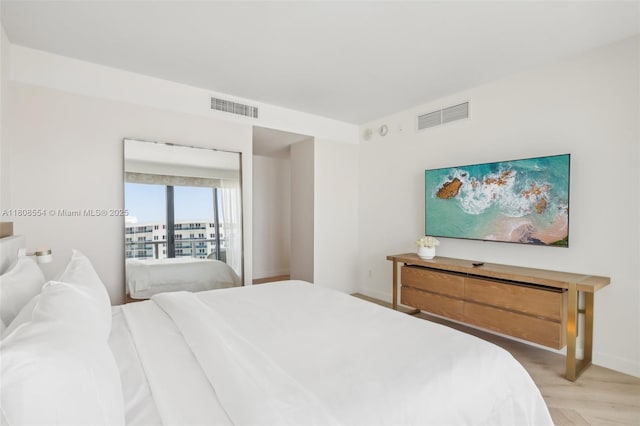 2201 Collins Ave Unit 1511, Miami Beach, FL 33139 - bedroom featuring light wood-type flooring and baseboards