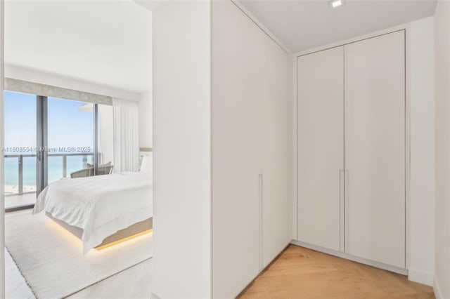 2201 Collins Ave Unit 1511, Miami Beach, FL 33139 - bedroom featuring access to exterior, light wood-style floors, a water view, and a closet