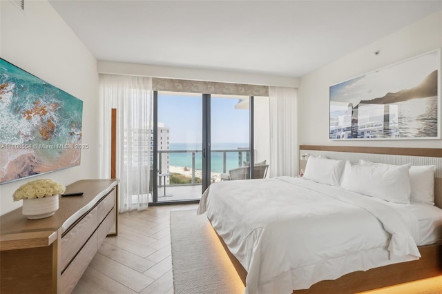 2201 Collins Ave Unit 1511, Miami Beach, FL 33139 - bedroom featuring access to outside, light wood-style floors, and a water view