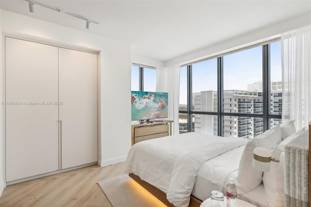 2201 Collins Ave Unit 1511, Miami Beach, FL 33139 - bedroom with rail lighting and light wood finished floors
