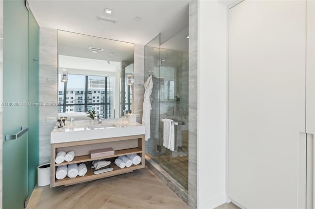 2201 Collins Ave Unit 1511, Miami Beach, FL 33139 - bathroom featuring vanity, a stall shower, and wood finished floors