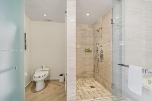 2201 Collins Ave Unit 1511, Miami Beach, FL 33139 - bathroom featuring a shower stall, toilet, and wood finished floors