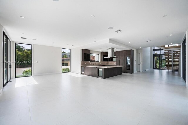 1351 Stillwater Dr, Miami Beach, FL 33141 - unfurnished living room with a wall of windows and a sink