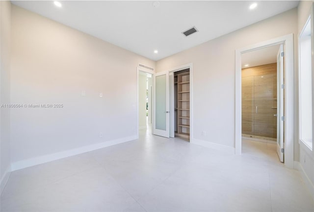 1351 Stillwater Dr, Miami Beach, FL 33141 - unfurnished bedroom featuring recessed lighting, a closet, concrete floors, and connected bathroom