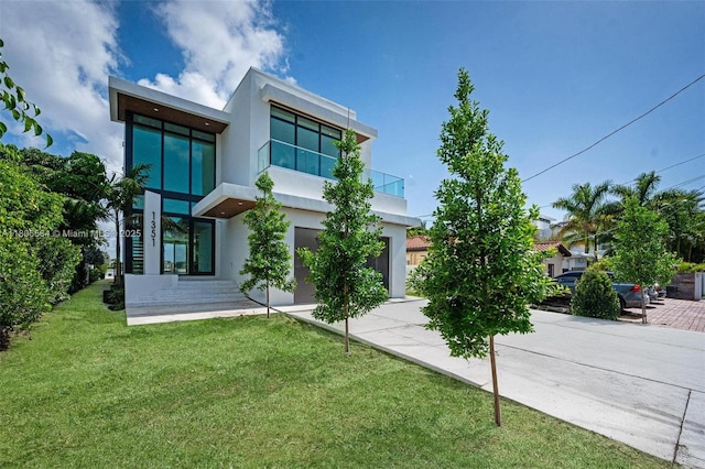 1351 Stillwater Dr, Miami Beach, FL 33141 - back of property featuring stucco siding, a balcony, and a lawn