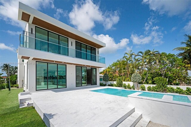 1351 Stillwater Dr, Miami Beach, FL 33141 - back of house featuring a balcony, stucco siding, and a patio