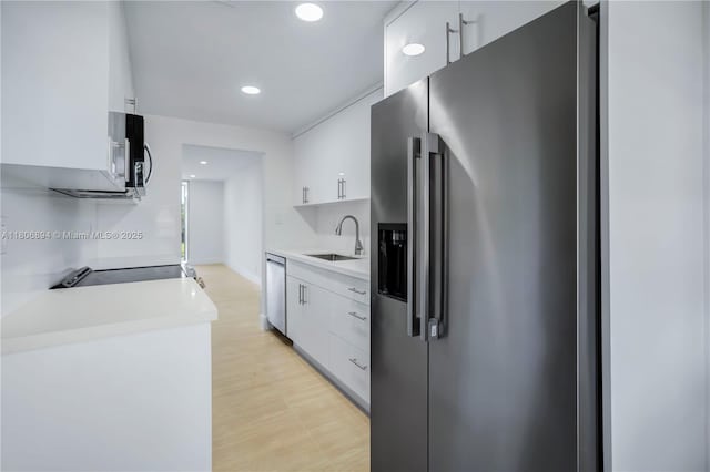 3361 NW 47th Ter Unit 329, Lauderdale Lakes, FL 33319 - kitchen with stainless steel appliances, a sink, white cabinets, light countertops, and recessed lighting