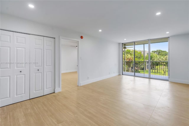 3361 NW 47th Ter Unit 329, Lauderdale Lakes, FL 33319 - unfurnished bedroom with access to outside, expansive windows, recessed lighting, baseboards, and a closet