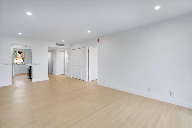 3361 NW 47th Ter Unit 329, Lauderdale Lakes, FL 33319 - empty room featuring recessed lighting, baseboards, and light wood-type flooring