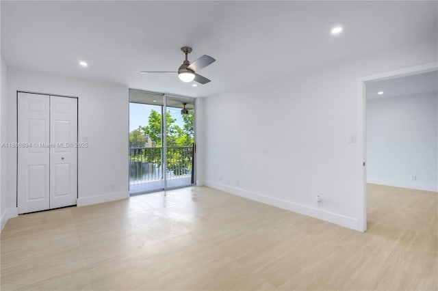 3361 NW 47th Ter Unit 329, Lauderdale Lakes, FL 33319 - unfurnished bedroom with access to outside, baseboards, recessed lighting, a wall of windows, and ceiling fan