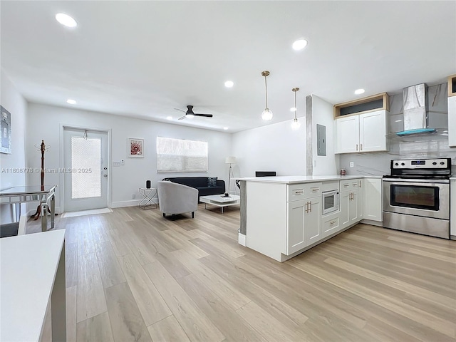 515 Monaco K Unit 515, Delray Beach, FL 33446 - kitchen with stainless steel range with electric cooktop, wall chimney exhaust hood, built in microwave, light wood-style floors, and electric panel