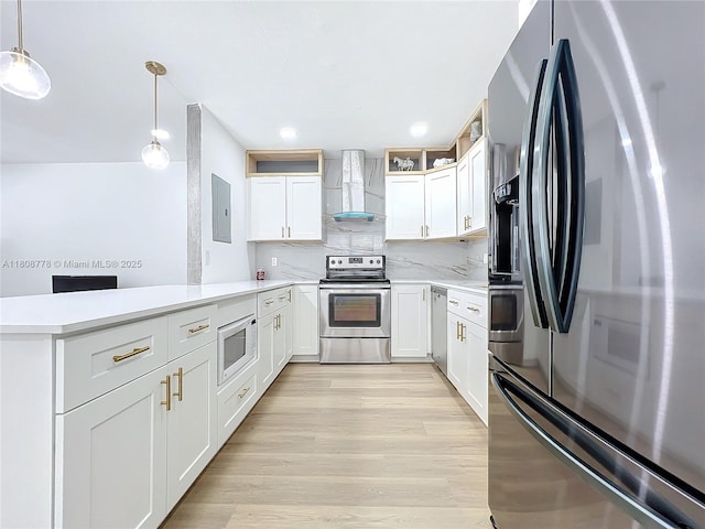 515 Monaco K Unit 515, Delray Beach, FL 33446 - kitchen with appliances with stainless steel finishes, wall chimney exhaust hood, a peninsula, light countertops, and tasteful backsplash