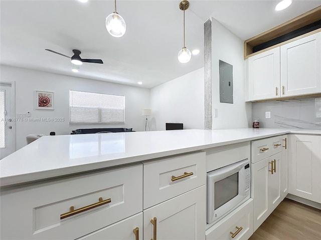 515 Monaco K Unit 515, Delray Beach, FL 33446 - kitchen with electric panel, light countertops, white cabinetry, a peninsula, and recessed lighting