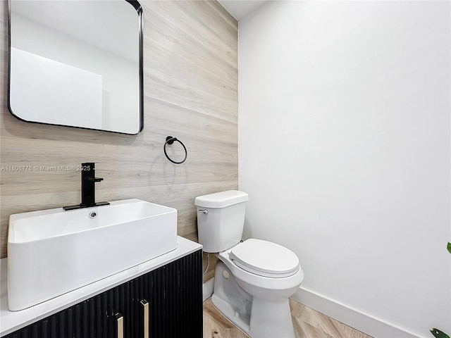515 Monaco K Unit 515, Delray Beach, FL 33446 - bathroom with toilet, vanity, baseboards, and wood finished floors