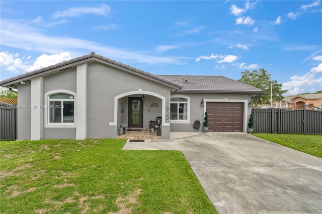 17833 SW 149th Pl, Miami, FL 33187 - view of front of house featuring driveway, an attached garage, a tiled roof, and stucco siding