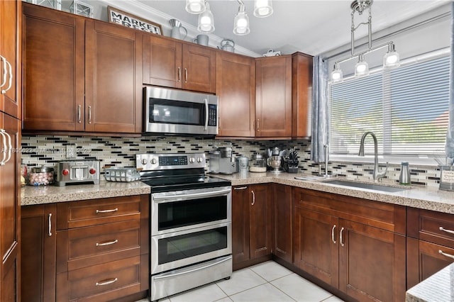 17833 SW 149th Pl, Miami, FL 33187 - kitchen with stainless steel appliances, decorative backsplash, ornamental molding, light tile patterned flooring, and pendant lighting