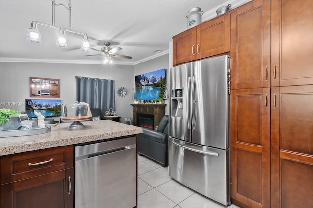 17833 SW 149th Pl, Miami, FL 33187 - kitchen featuring stainless steel appliances, crown molding, ceiling fan, light tile patterned floors, and light countertops