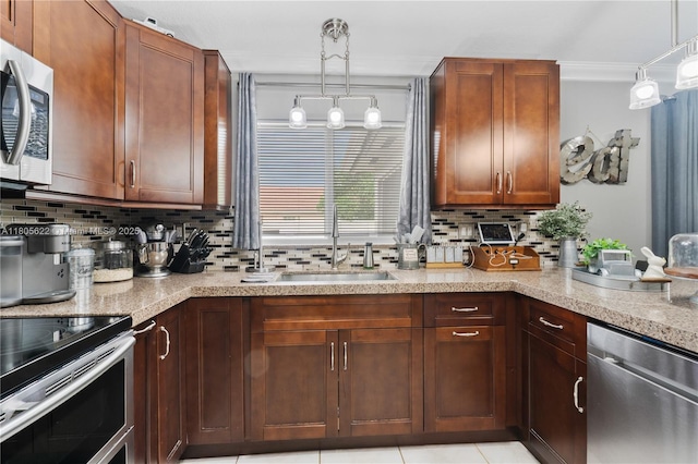17833 SW 149th Pl, Miami, FL 33187 - kitchen with stainless steel appliances, tasteful backsplash, hanging light fixtures, and light stone countertops