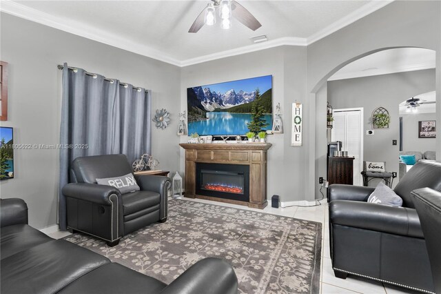 17833 SW 149th Pl, Miami, FL 33187 - living area with a ceiling fan, arched walkways, crown molding, a glass covered fireplace, and tile patterned flooring