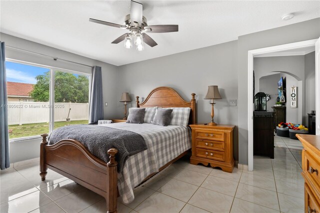 17833 SW 149th Pl, Miami, FL 33187 - bedroom with arched walkways, a ceiling fan, and light tile patterned floors
