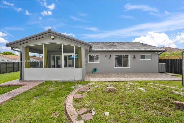 17833 SW 149th Pl, Miami, FL 33187 - rear view of house featuring a sunroom, a patio, a tile roof, and stucco siding
