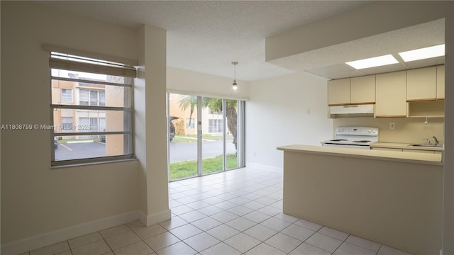 9300 W Flagler St Unit 112D, Miami, FL 33174 - kitchen with electric stove, under cabinet range hood, baseboards, light tile patterned floors, and a textured ceiling