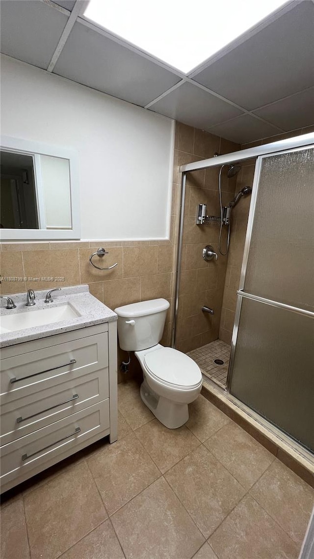 9300 W Flagler St Unit 112D, Miami, FL 33174 - bathroom with toilet, a shower stall, vanity, tile walls, and tile patterned flooring
