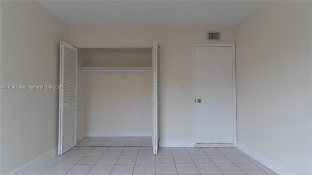 9300 W Flagler St Unit 112D, Miami, FL 33174 - unfurnished bedroom featuring a closet, light tile patterned floors, and baseboards