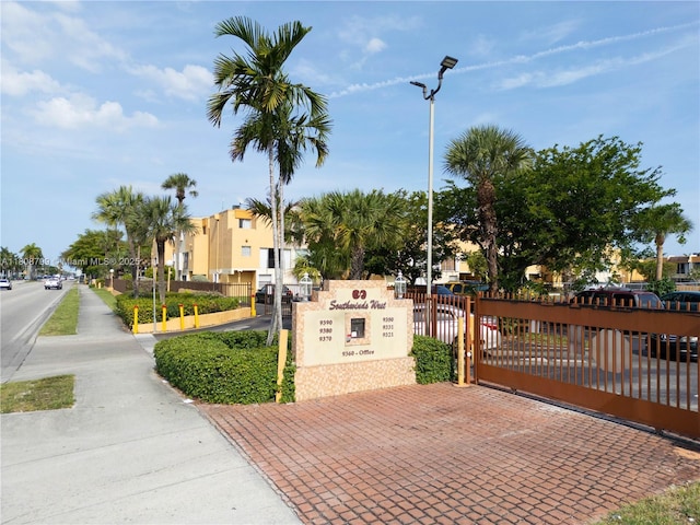 9300 W Flagler St Unit 112D, Miami, FL 33174 - view of asphalt street with sidewalks, street lights, a gate, and a residential view