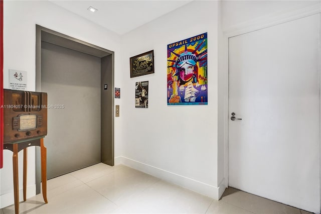 16385 Biscayne Blvd Unit 3217, North Miami Beach, FL 33160 - hallway featuring elevator, light tile patterned flooring, and baseboards