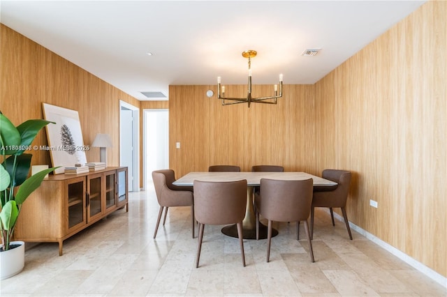 68 SE 6th St Unit 1403, Miami, FL 33131 - dining space featuring a chandelier and wooden walls