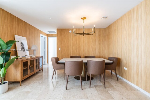 68 SE 6th St Unit 1403, Miami, FL 33131 - dining space with a chandelier and wood walls