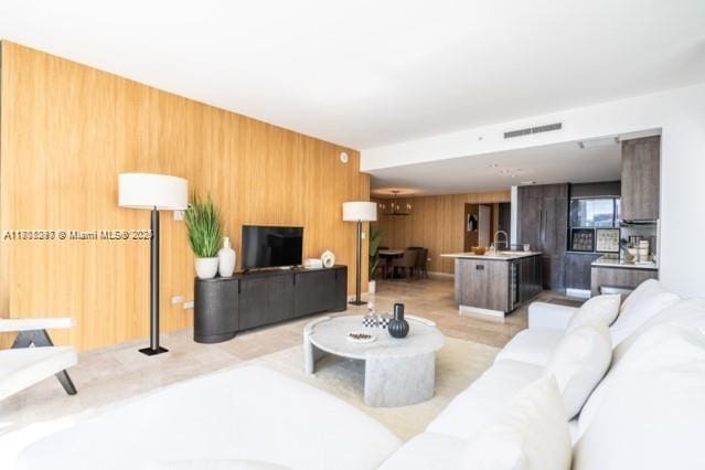 68 SE 6th St Unit 1403, Miami, FL 33131 - living area featuring wood walls