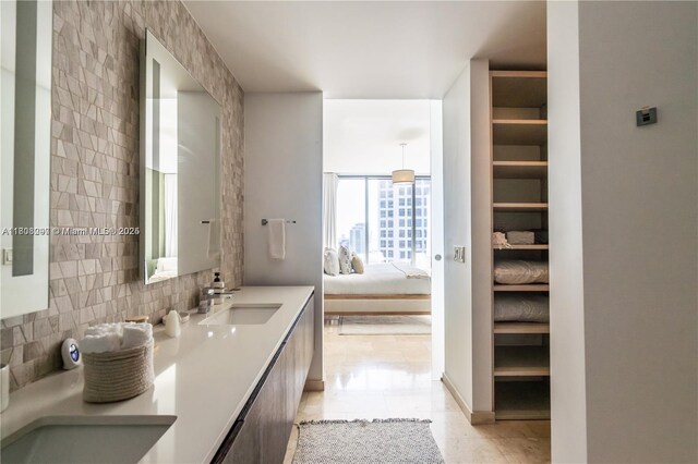68 SE 6th St Unit 1403, Miami, FL 33131 - full bathroom with connected bathroom, tasteful backsplash, double vanity, and tile patterned floors