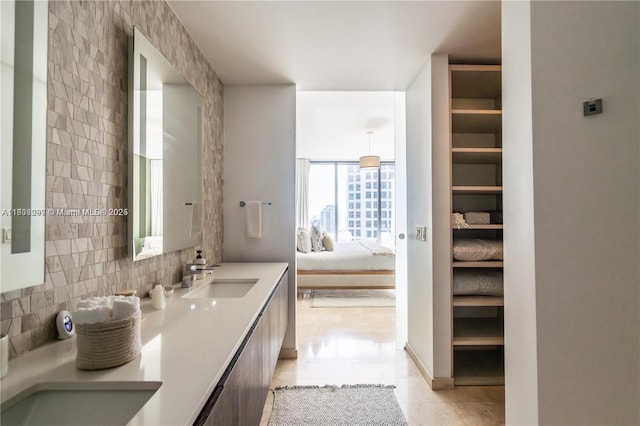 68 SE 6th St Unit 1403, Miami, FL 33131 - ensuite bathroom with backsplash, double vanity, and tile patterned floors