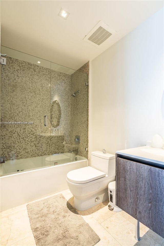 68 SE 6th St Unit 1403, Miami, FL 33131 - full bathroom featuring toilet, combined bath / shower with glass door, vanity, and tile patterned flooring