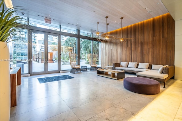 68 SE 6th St Unit 1403, Miami, FL 33131 - community lobby with wooden walls, expansive windows, wooden ceiling, and a towering ceiling