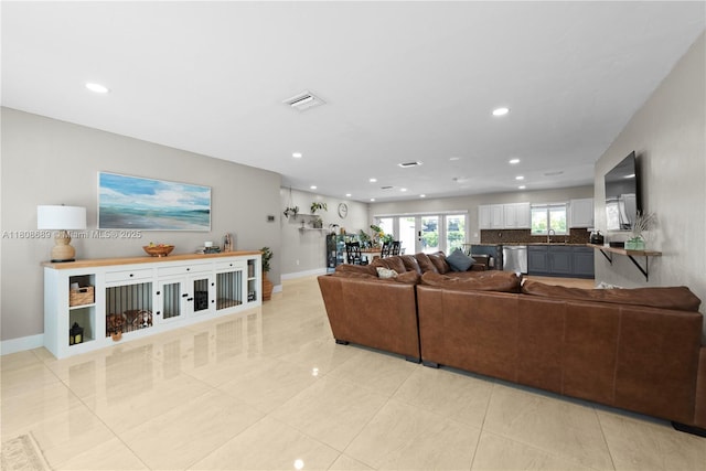 19525 SW 272nd St, Homestead, FL 33031 - living room with recessed lighting, light tile patterned floors, and baseboards