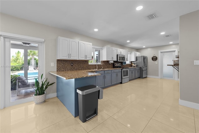 19525 SW 272nd St, Homestead, FL 33031 - kitchen featuring stainless steel appliances, white cabinetry, baseboards, and recessed lighting