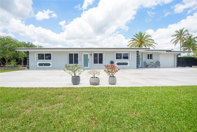 19525 SW 272nd St, Homestead, FL 33031 - view of front of home featuring stucco siding, a front yard, a garage, and driveway