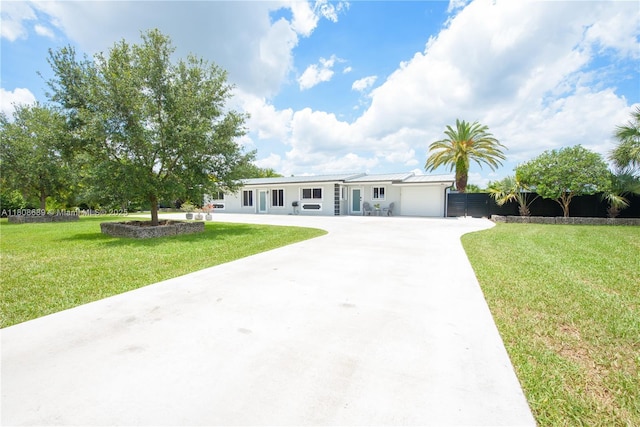 19525 SW 272nd St, Homestead, FL 33031 - ranch-style house with driveway, a front yard, an attached garage, and metal roof