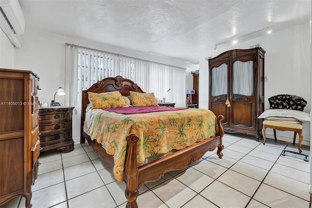 2442 Fillmore St, Hollywood, FL 33020 - bedroom featuring a wall mounted air conditioner, light tile patterned flooring, and a textured ceiling