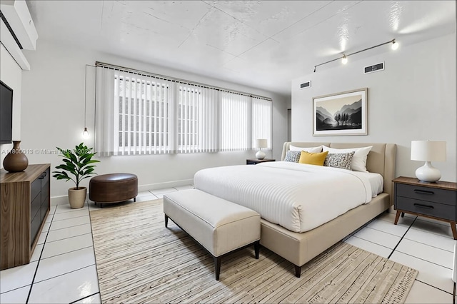 2442 Fillmore St, Hollywood, FL 33020 - bedroom with light tile patterned floors and rail lighting