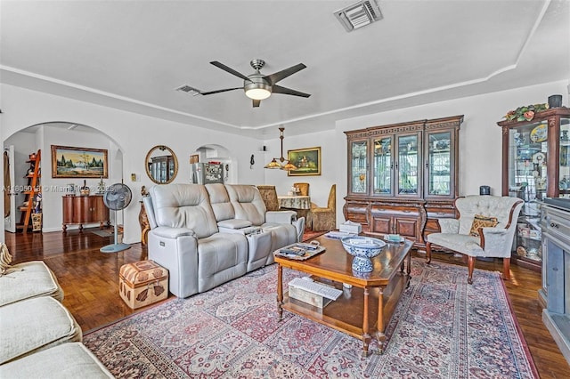 2442 Fillmore St, Hollywood, FL 33020 - living room with arched walkways, a ceiling fan, a tray ceiling, and wood finished floors