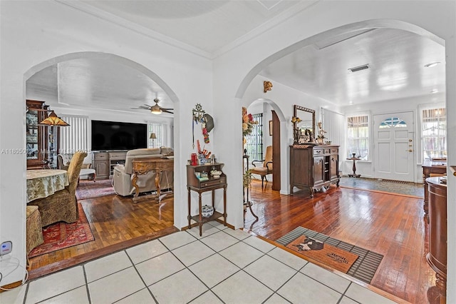2442 Fillmore St, Hollywood, FL 33020 - foyer entrance with wood-type flooring, ceiling fan, crown molding, and arched walkways