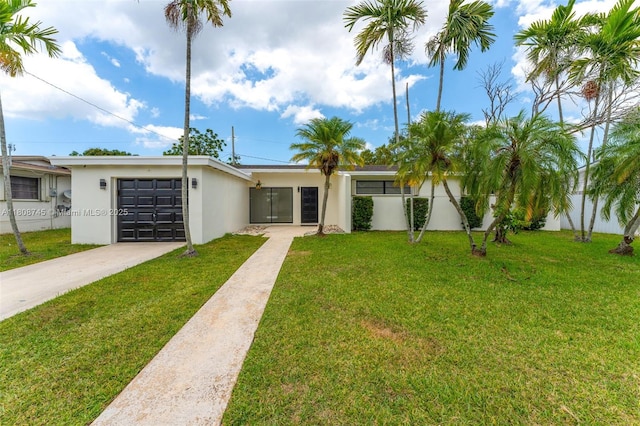 17761 SW 113th Ct, Miami, FL 33157 - view of front of house with driveway, stucco siding, a front yard, and an attached garage
