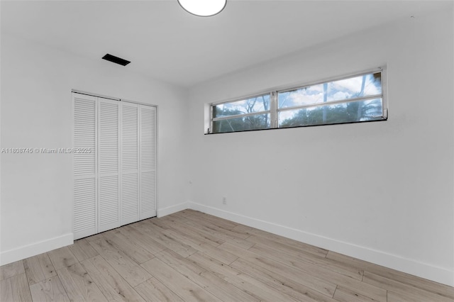 17761 SW 113th Ct, Miami, FL 33157 - unfurnished bedroom featuring light wood finished floors, a closet, and baseboards