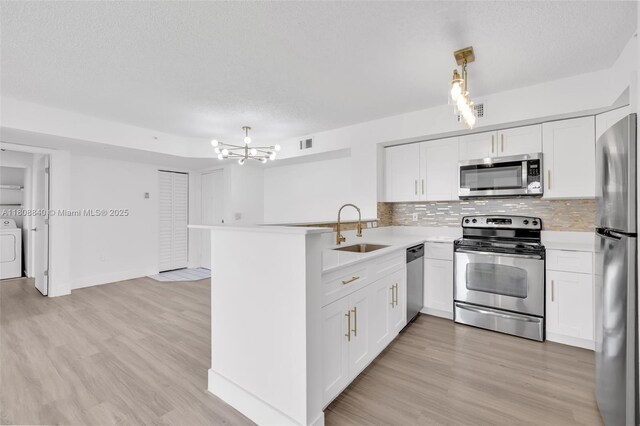 2173 Renaissance Blvd Unit 204, Miramar, FL 33025 - kitchen with appliances with stainless steel finishes, washer and dryer, light countertops, tasteful backsplash, and white cabinets