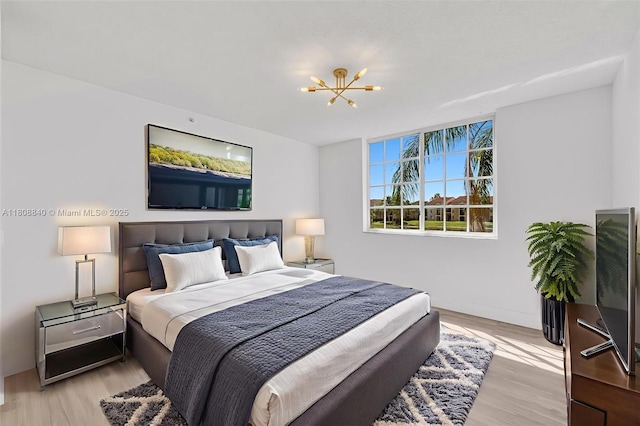 2173 Renaissance Blvd Unit 204, Miramar, FL 33025 - bedroom with a chandelier and light wood finished floors