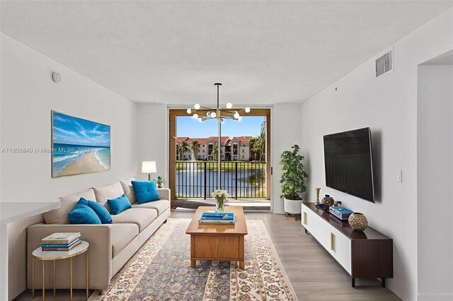 2173 Renaissance Blvd Unit 204, Miramar, FL 33025 - living area with a chandelier and wood finished floors